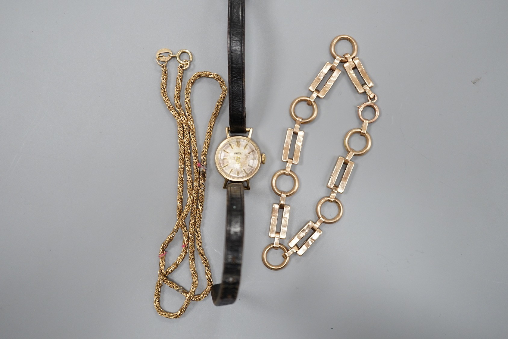 A 9ct bracelet, a 9kt necklace, 11.5 grams, and a lady's 9ct gold Smiths, manual wind wrist watch, on a leather strap, gross 9.2 grams.